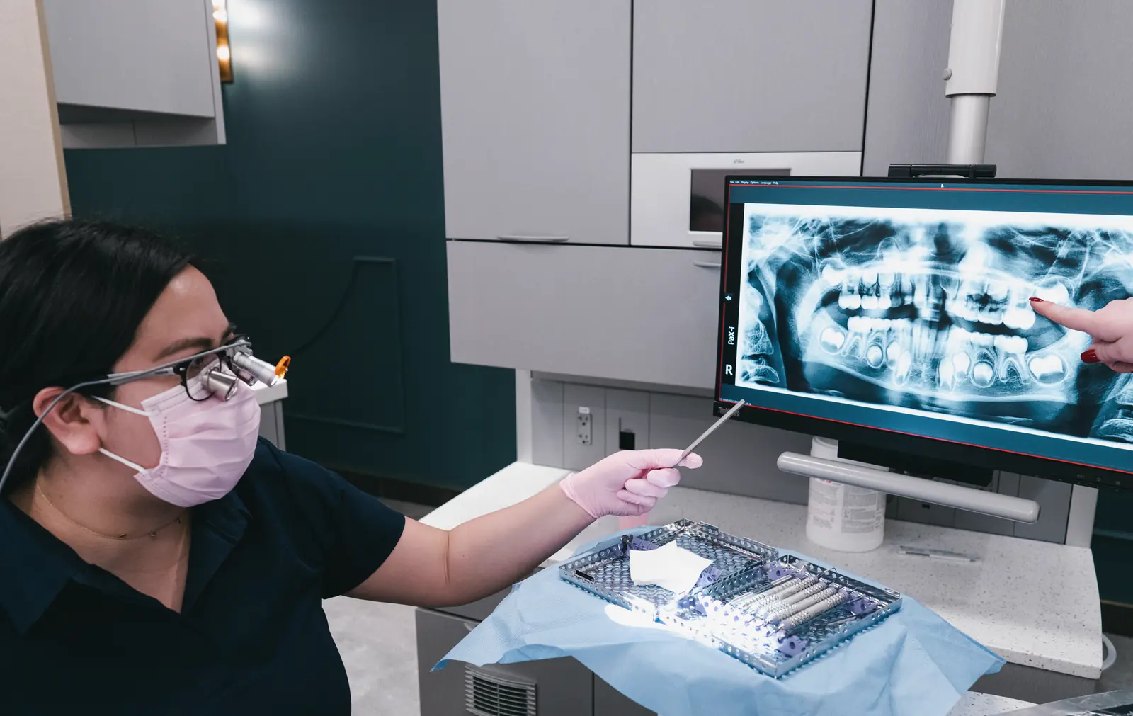 Dr. Kat reviewing a panoramic X-ray in the treatment room